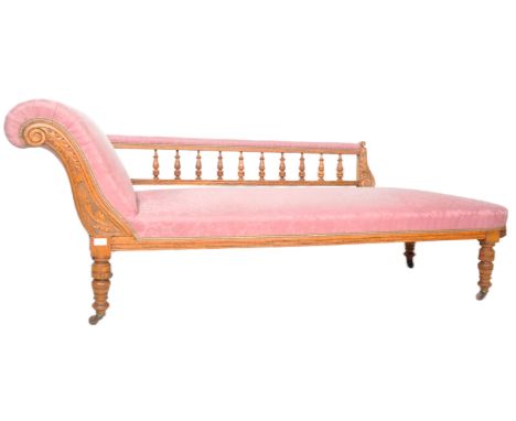 An early 20th Century Edwardian carved oak chaise longue daybed. scrolled arm with turned gallery back, overstuffed seat base