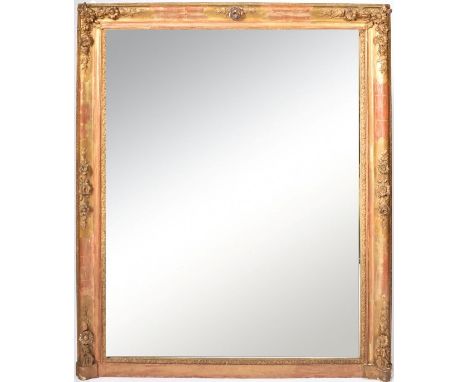 A large mid 19th Century gilded overmantel mirror having a large single mirror plate with inner foliate worked cushion. Outer