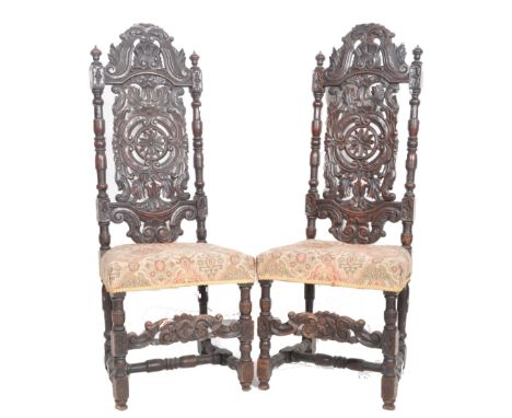 A pair of 19th Century walnut Carolean revival carved hall chairs / throne chairs.Tall intricate carved backrest with 'C' scr