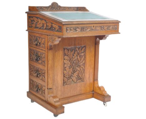 A 19th Century Victorian highly detailed carved oak Davenport writing table desk having high relief carved acorn handles to t