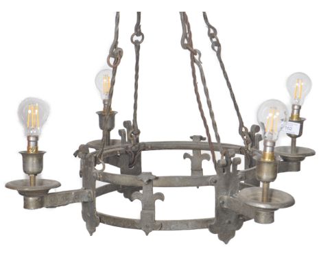 A 19th Century Victorian wrought iron hanging chandelier light having a circular frame with four protruding arms each with li