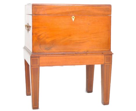 An early 19th Century Regency mahogany workbox on stand of large size. Comprises the box with hinged lid and brass handles ra