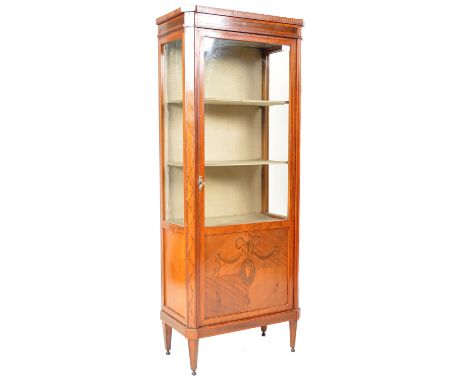 A 19th Century Victorian Maple &amp; Co upright satin wood cabinet vitrine having a full length door with three quarter glass