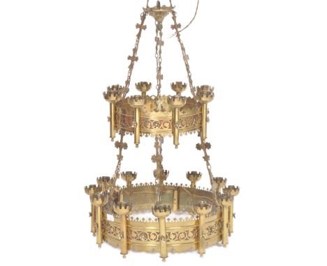 A 19th Century Gothic brass worked chandelier light of two tier ecclesiastical circular form. Each tier with pierced foliate 
