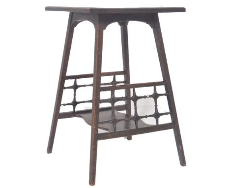 An early 20th Century Arts &amp; Crafts oak side table / torchere stand having a square top with splayed legs united by tiere