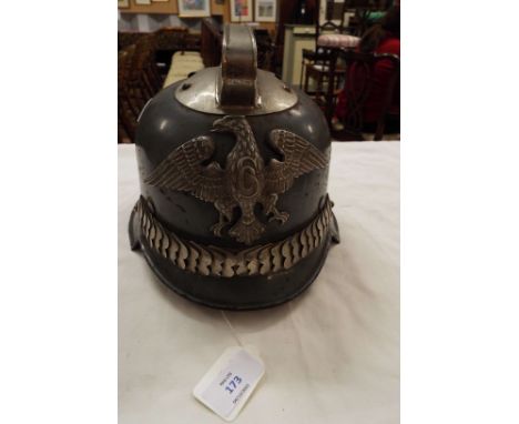 A WWII German fireman's helmet with applied eagle cap badge