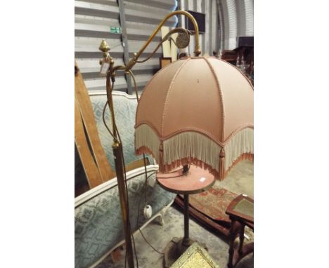 A late Victorian rise and fall reading light the floral moulded adjustable arm raised on a fluted column support and circular