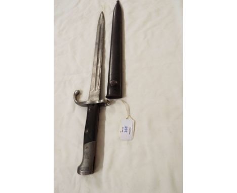 A German WWII military bayonet in metal scabbard