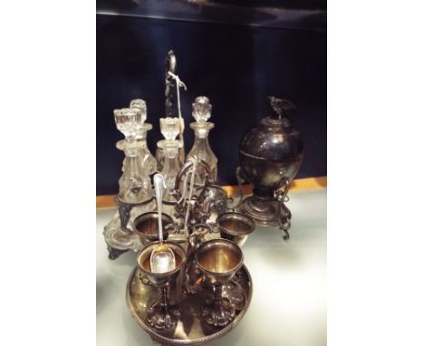 A late Victorian silver-plated egg coddler and burner with bird and nest finial, a Victorian silver-plated nine bottle cruet 