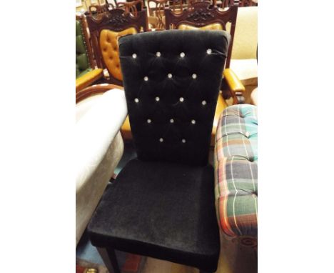 A black upholstered high back side chair, the back decorated with faux crystals over a padded seat, raised on square tapering