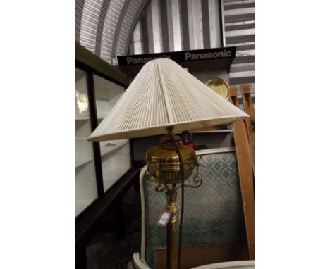 A 19thC brass messengers patent oil fuelled standard lamp converted to electricity, the gadrooned reservoir raised on a flute