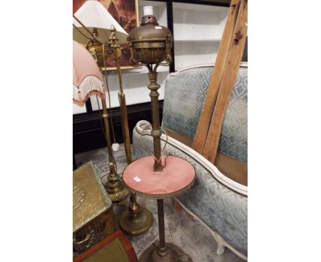 An antique brass standard lamp