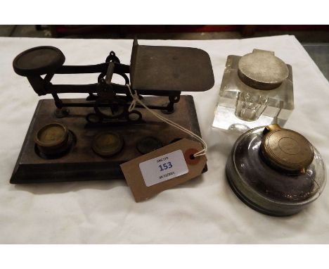 Two early 20thC glass inkwells together with a set of brass postal scales