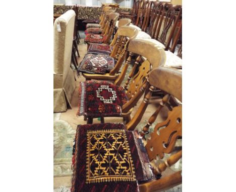 A set of eight elm farmhouse dining chairs with spindle and pierce splat backs, solid seat and raised on ring turned supports