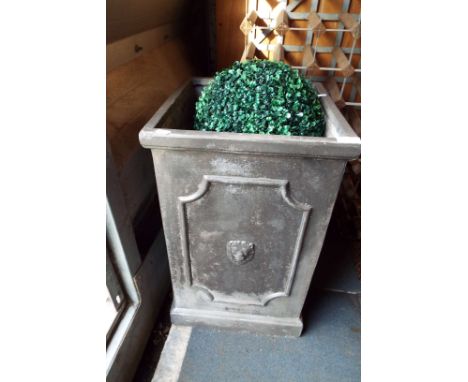 A fibre clay planter with terracotta pots and two sphere shaped plants