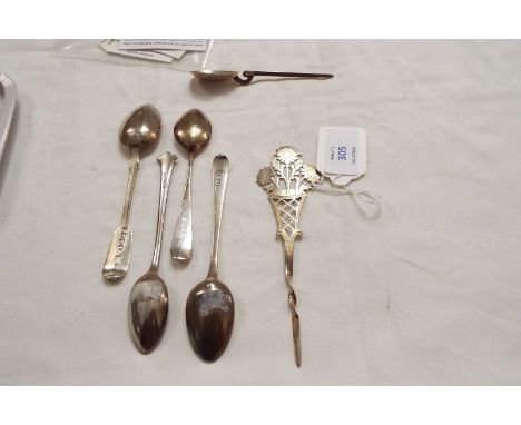 Four silver tea spoons of various dates and a Sheffield silver ornate swizzle stick having fret work vase of flowers 