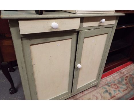 A painted wooden two-door cabinet with drawers above, and single shelf below