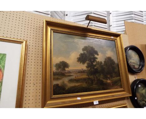 A 19thC oil on canvas landscape view with figures to the foreground and windmill beyond, framed in plain gilt with attached p