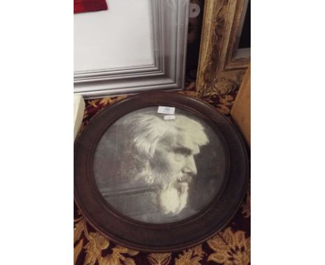A graphite portrait of Thomas Carlyle set into a circular oak frame
