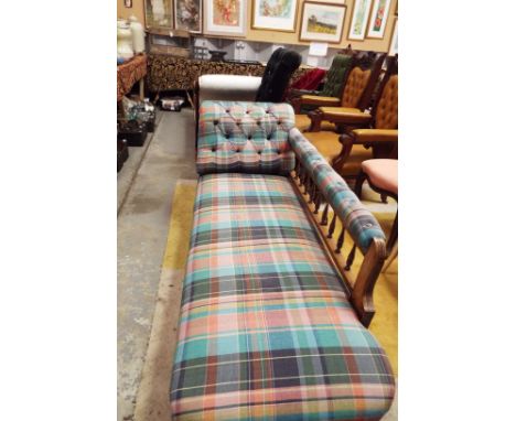 An Edwardian walnut framed spindle back chaise longue upholstered in a button-back chequered fabric 