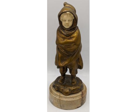 Antoine Bofill (Spanish, fl.1895-1921), Boy wrapped in a coat, bronze with patinated gold and ivory face, raised on marble ba