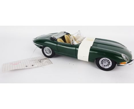 Franklin Mint 1;24 scale die-cast model of a 1961 open top E-Type Jaguar, green with wire wheels, mint boxed