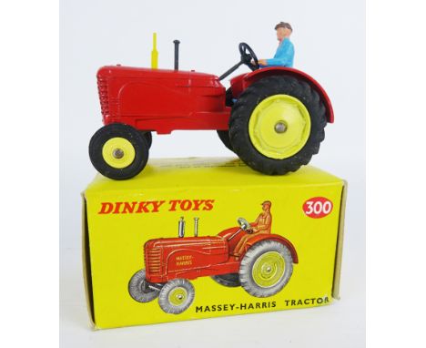Dinky Toys die-cast model 300 Massey-Harris Tractor, red body with pale yellow hubs & exhaust, blue driver, boxed   Condition