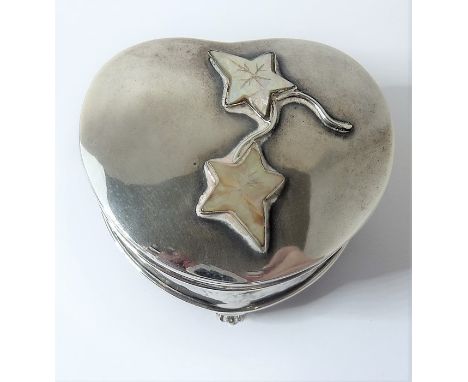 An early 20th century heart-shaped hallmarked silver trinket box; the interior blue-silk-lined and the lid decorated with eng