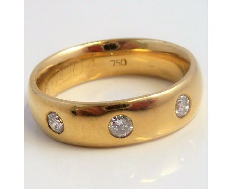 A diamond-set band ring, the top section gypsy-set with three brilliant-cut diamonds stamped '750', size J (gross weight 6.1g