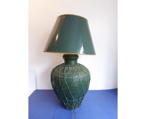 A large baluster-shaped green-painted tin lamp with woven lattice-work effect decoration in relief together with matching con