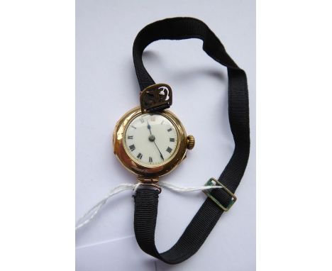 An 18-carat yellow-gold-cased dress wristwatch; white-enamel dial with Roman numerals and on black linen strap (appears in go