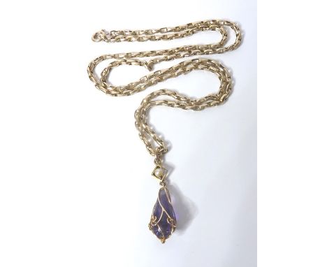 A 9-carat gold (marked 9CT) chain together with a seed pearl and pear-shaped amethyst pendant drop within a wirework cage (to