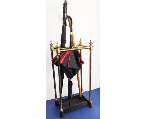 An early 20th century six-division brass stick-stand with&nbsp;iron base (62cm high); together with two&nbsp;umbrellas and a 