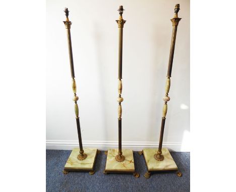 Three onyx and gilt-metal mounted standard lamps having Corinthian-style columns (142cm including light fitting) (3)