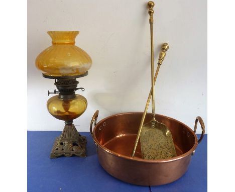 A 19th century two-handled copper preserve pan together with two brass fire irons and a late 19th century oil lamp having amb