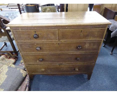 A George III period early 19th century oak chest; the moulded top above two half-width and three full-width graduated drawers