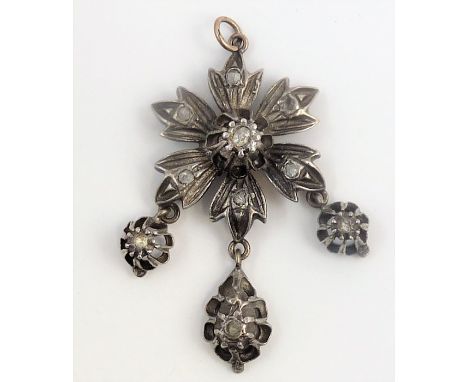 A early/mid-19th century diamond-set and silver pendant, the flower-head cluster suspending three drops all with diamond-set 