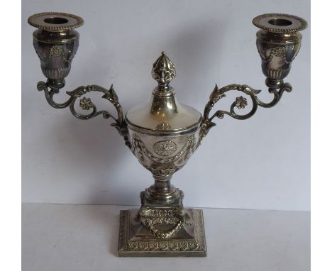 A 19th century silver plated two-light candelabra in high Neo-Classical style; the central lidded urn flanked by two candle a