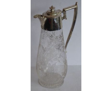 A late 19th century baluster-shaped glass claret jug with silver-plated mounts; the main body very finely engraved with scrol