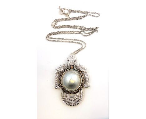 A mabé pearl and diamond-set pendant, the central mabé pearl measuring 15mm approx. in diameter within a surround of brillian