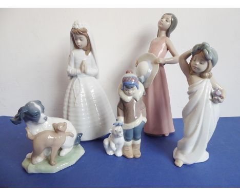 Three Lladro and two Nao porcelain figures; the Nao figures of a girl in first communion dress (23cm high) and a spaniel with