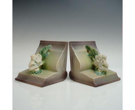 Ravishing pair of pottery bookends, each decorated with white blossoms and green leaves against an open book. Finished in a s