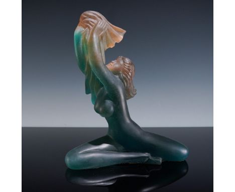 This striking Daum crystal sculpture features a kneeling nude woman gracefully raising a veil, executed in Daum's renowned pa