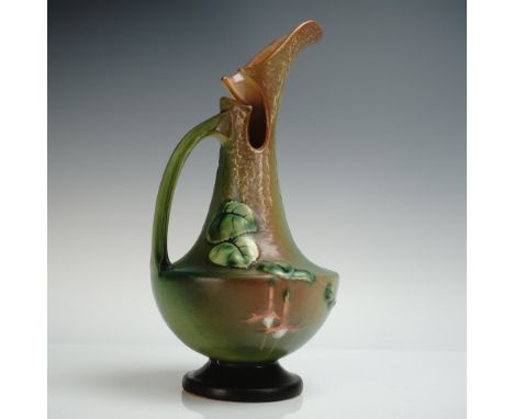 A Roseville Pottery ewer in the Fuchsia pattern, featuring cascading pink and lavender blossoms with green leaves against a b