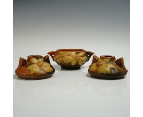 A nice set of pottery decor, comprising of a two handle sugar bowl and a pair of candle holders. Each vessel is decorated wit