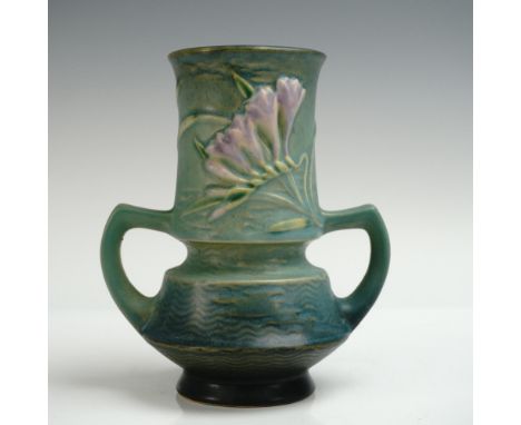 Double-handled vase from Roseville Pottery in the Freesia pattern, featuring sculpted freesia blossoms in soft pastel tones a