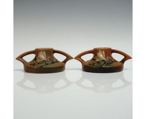 Pair of pottery holders in the Magnolia pattern featuring the distinctive double handled form with sculpted pink magnolia blo