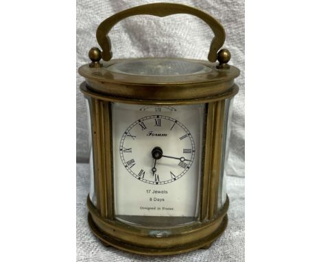 A miniature French brass carriage clock of oval form, 12cm high 