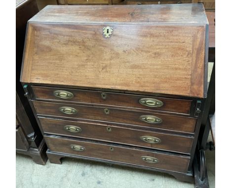 A George III mahogany bureau, the sloping fall enclosing a fitted interior of pigeon holes and drawers above four long gradua