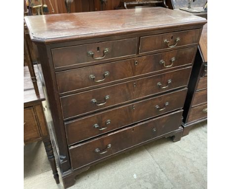 A George III mahogany chest, the rectangular top with cut corners above two short and four long drawers on bracket feet